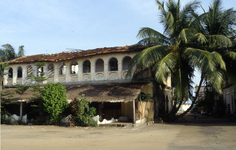 A colonial-era house in Grand-Bassam with a veranda and wooden shutters.