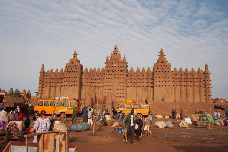 The mud-brick Great Mosque of Djenné with its towers, in front of the Monday market.